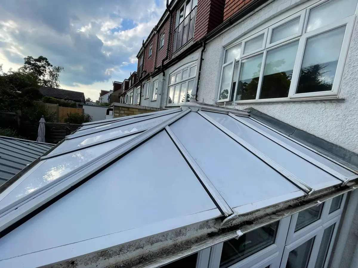 A tired polycarbonate conservatory roof before we replaced it
