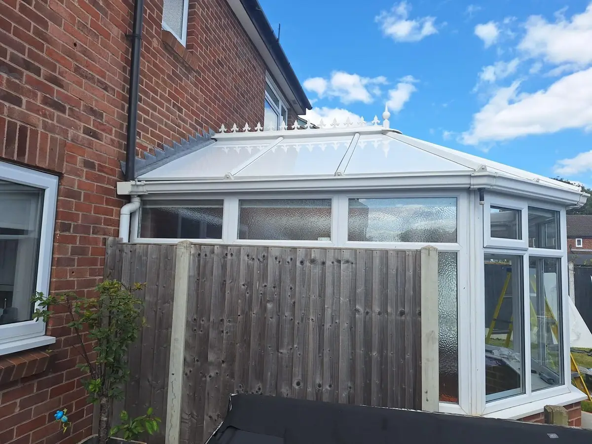 Sunshine on a Victorian conservatory with its completed white insulated roof