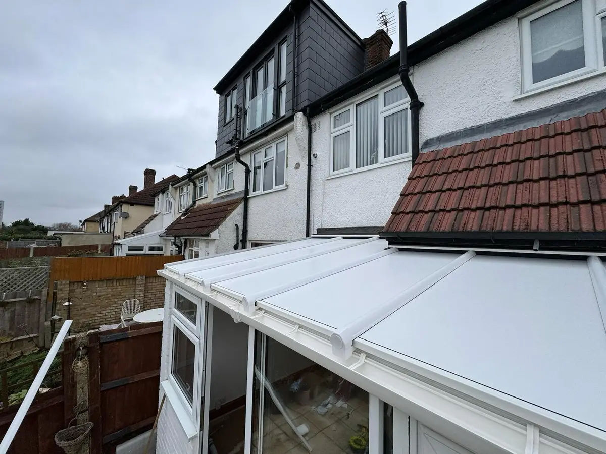 Terraced home with a newly fitted white insulated lean-to roof at the rear